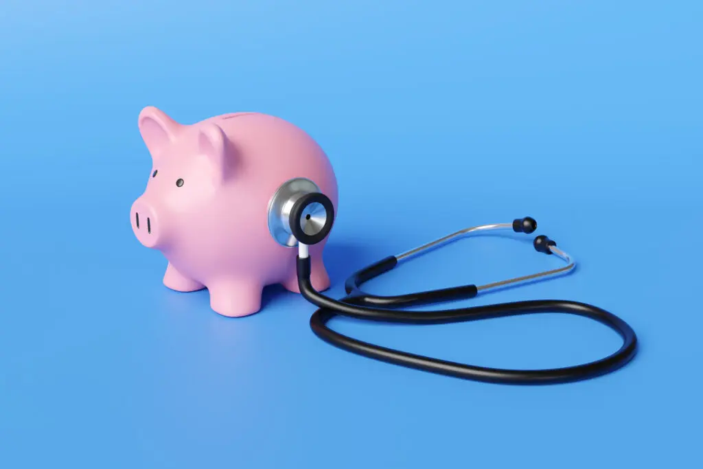 A stethoscope placed on a pink piggy bank, representing the desire to improve financial well-being for Alabama residents.
